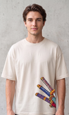 A male model wearing a premium off-white oversized t-shirt featuring three detailed katana hilts in high-density direct embroidery on the lower side