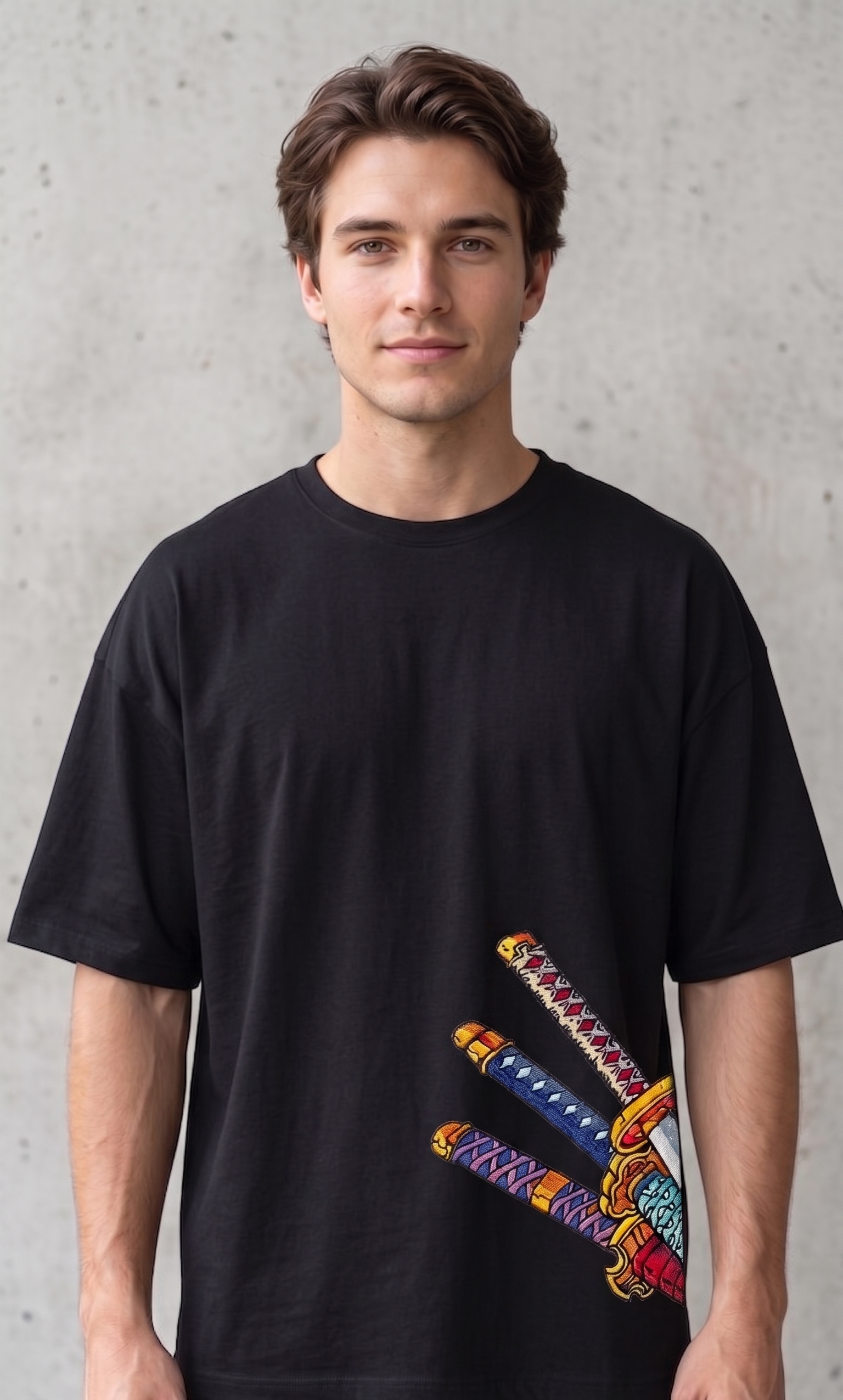 A male model wearing a premium oversized t-shirt featuring three detailed katana hilts in high-density direct embroidery on the lower side