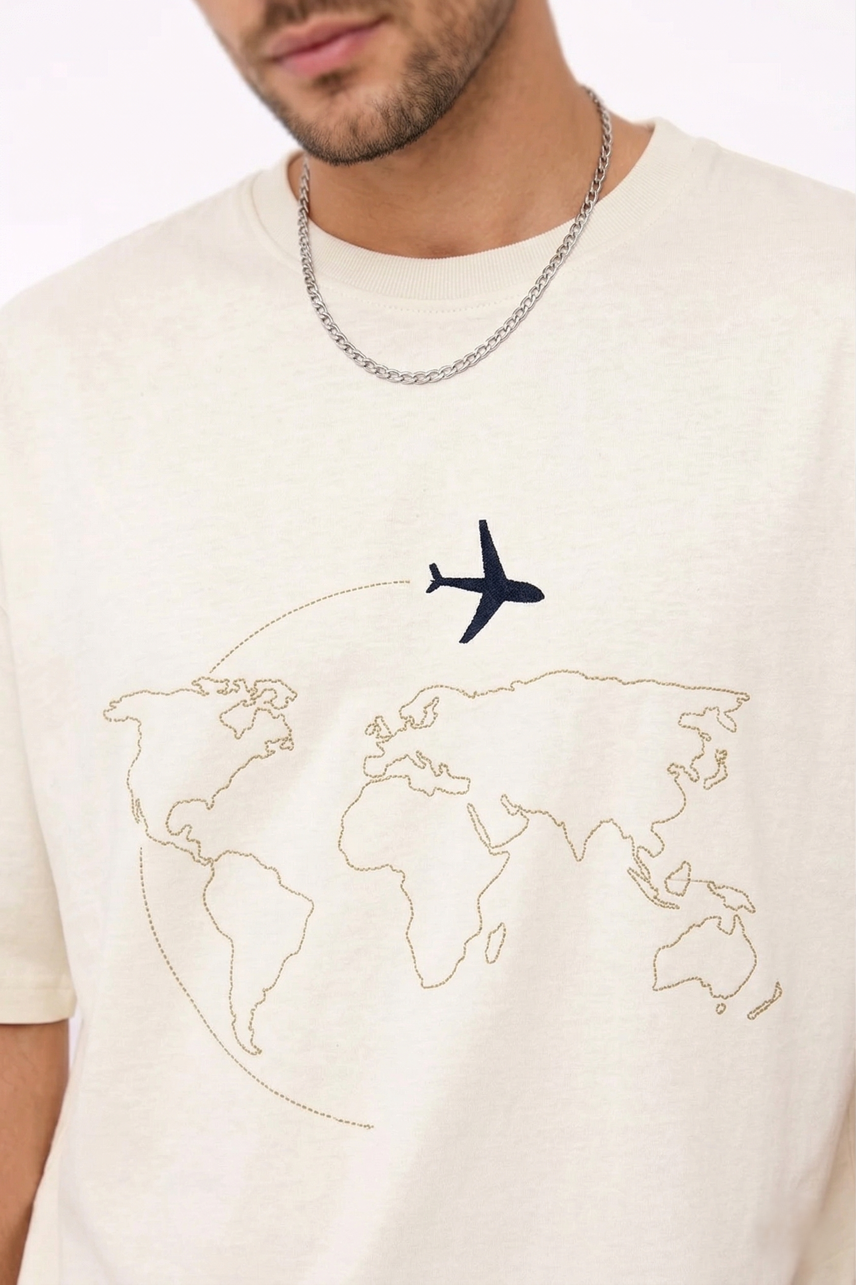"Anetoonz premium off-white oversized streetwear T-shirt for men with half sleeves and custom travel-themed world map embroidery."
