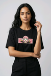 E-commerce product photo of an Indian model in a premium black streetwear t-shirt with detailed custom anime embroidery and a relaxed fit.