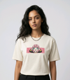 E-commerce product shot of an Indian model in a premium off-white streetwear t-shirt with detailed custom anime embroidery and a silver chain necklace.