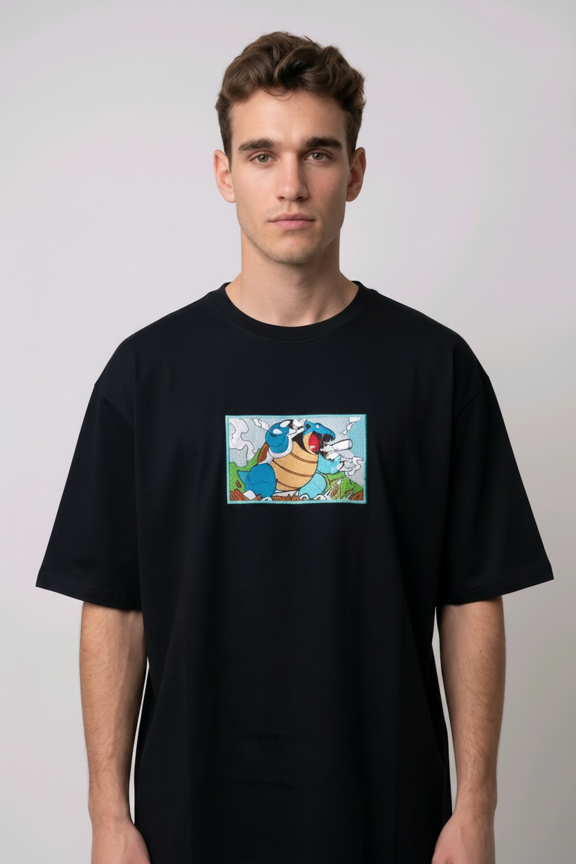 Front view of a black heavyweight T-shirt showcasing a high-quality embroidered scene of the Pokémon Blastoise.