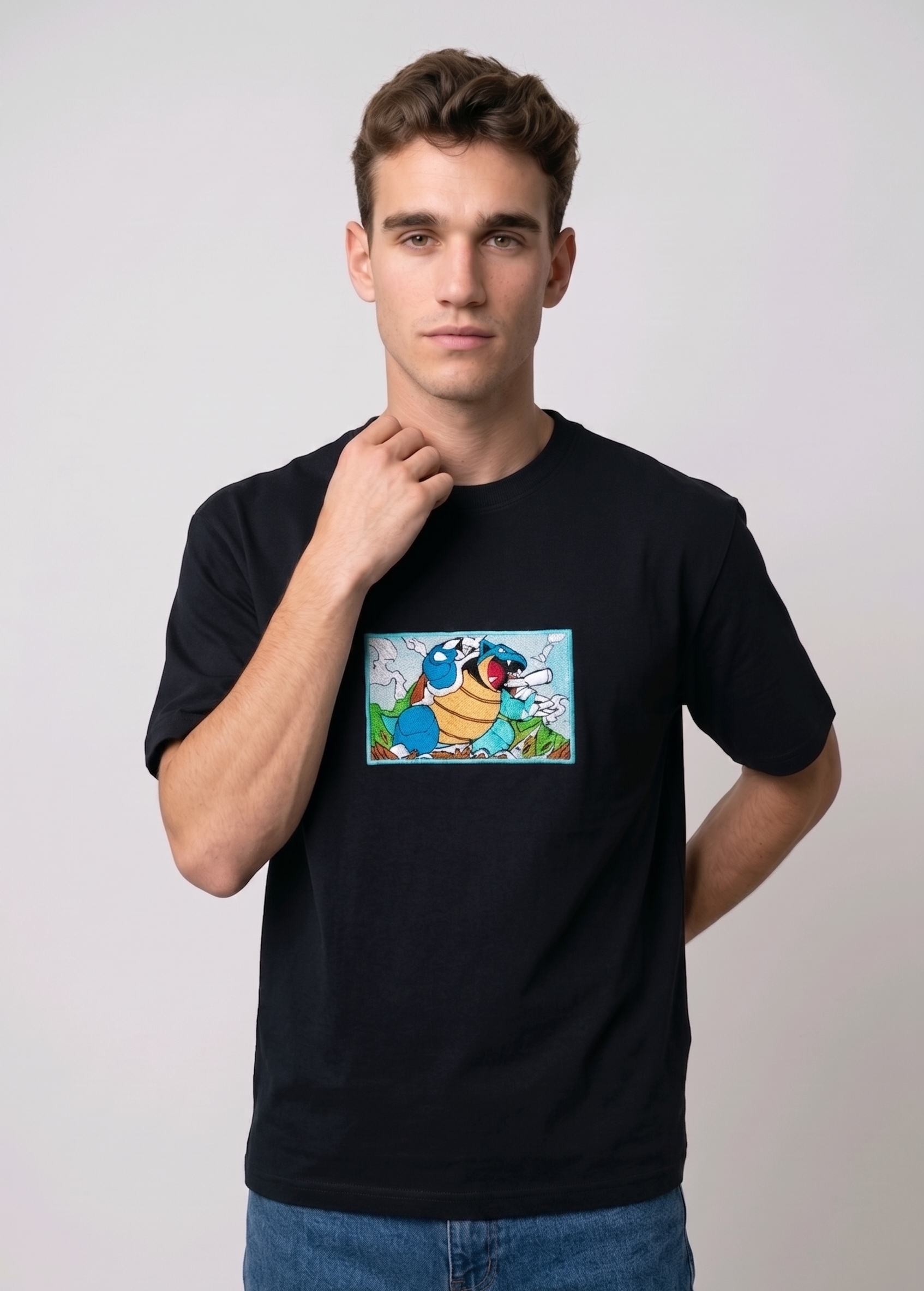 Front view of a black heavyweight T-shirt showcasing a high-quality embroidered scene of the Pokémon Blastoise.