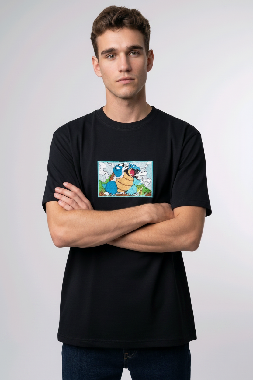 Front view of a black heavyweight T-shirt showcasing a high-quality embroidered scene of the Pokémon Blastoise.