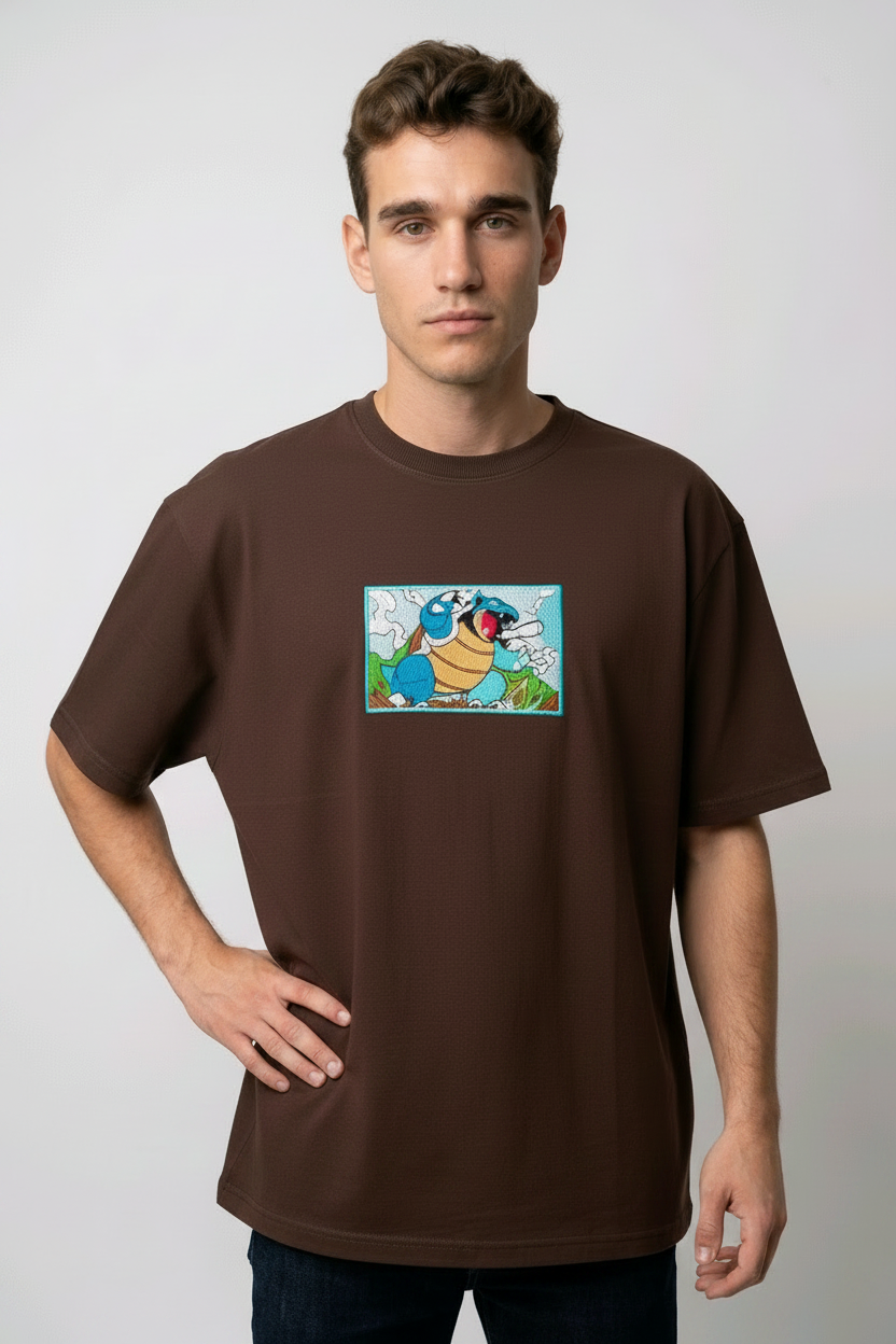 Front view of a brown heavyweight T-shirt showcasing a high-quality embroidered scene of the Pokémon Blastoise.