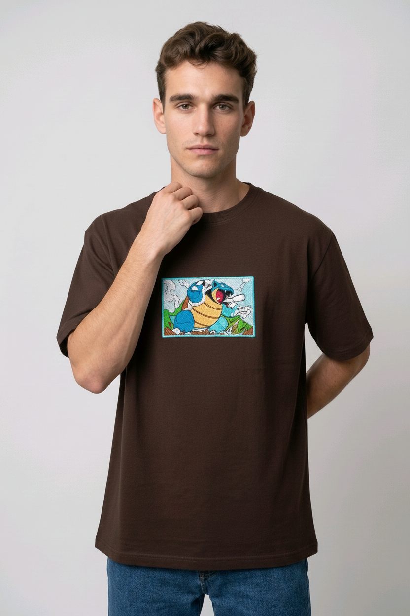 Front view of a brown heavyweight T-shirt showcasing a high-quality embroidered scene of the Pokémon Blastoise.