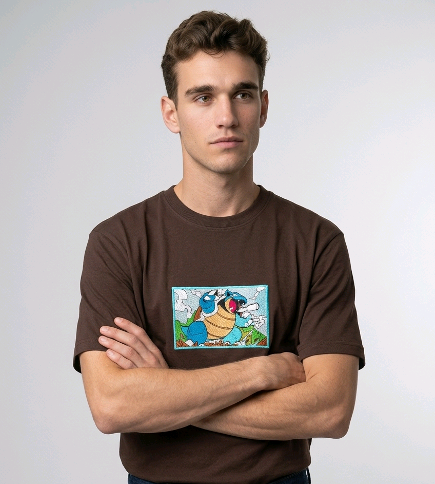 Front view of a brown heavyweight T-shirt showcasing a high-quality embroidered scene of the Pokémon Blastoise.