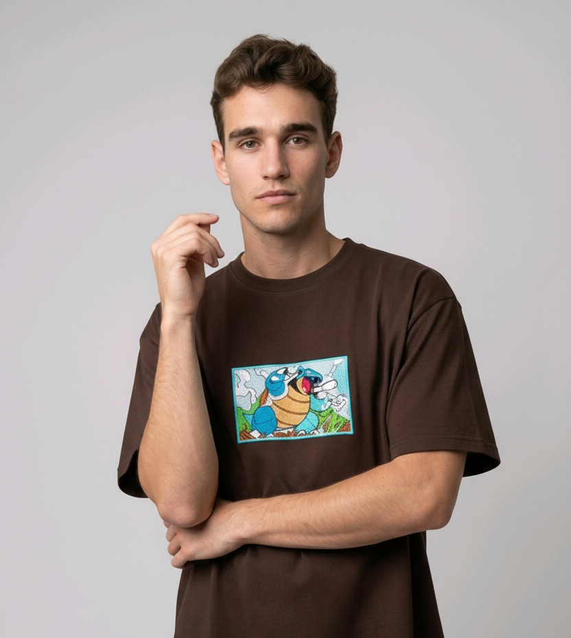 Front view of a brown heavyweight T-shirt showcasing a high-quality embroidered scene of the Pokémon Blastoise.