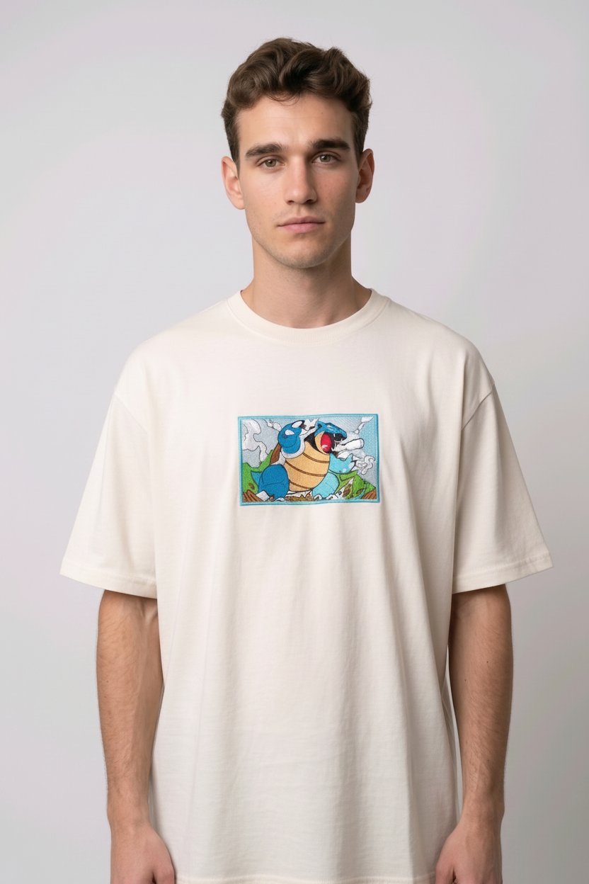 Front view of a off white heavyweight T-shirt showcasing a high-quality embroidered scene of the Pokémon Blastoise.