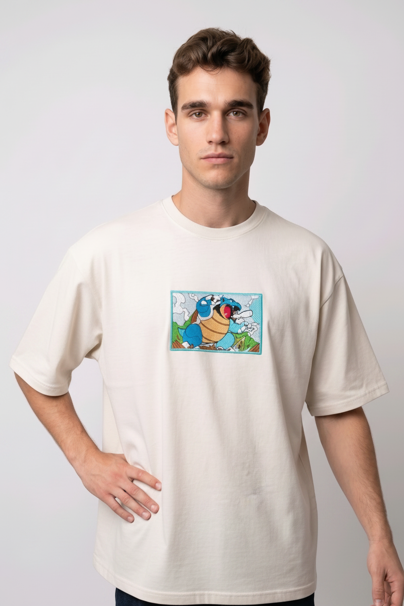 Front view of a off white heavyweight T-shirt showcasing a high-quality embroidered scene of the Pokémon Blastoise.