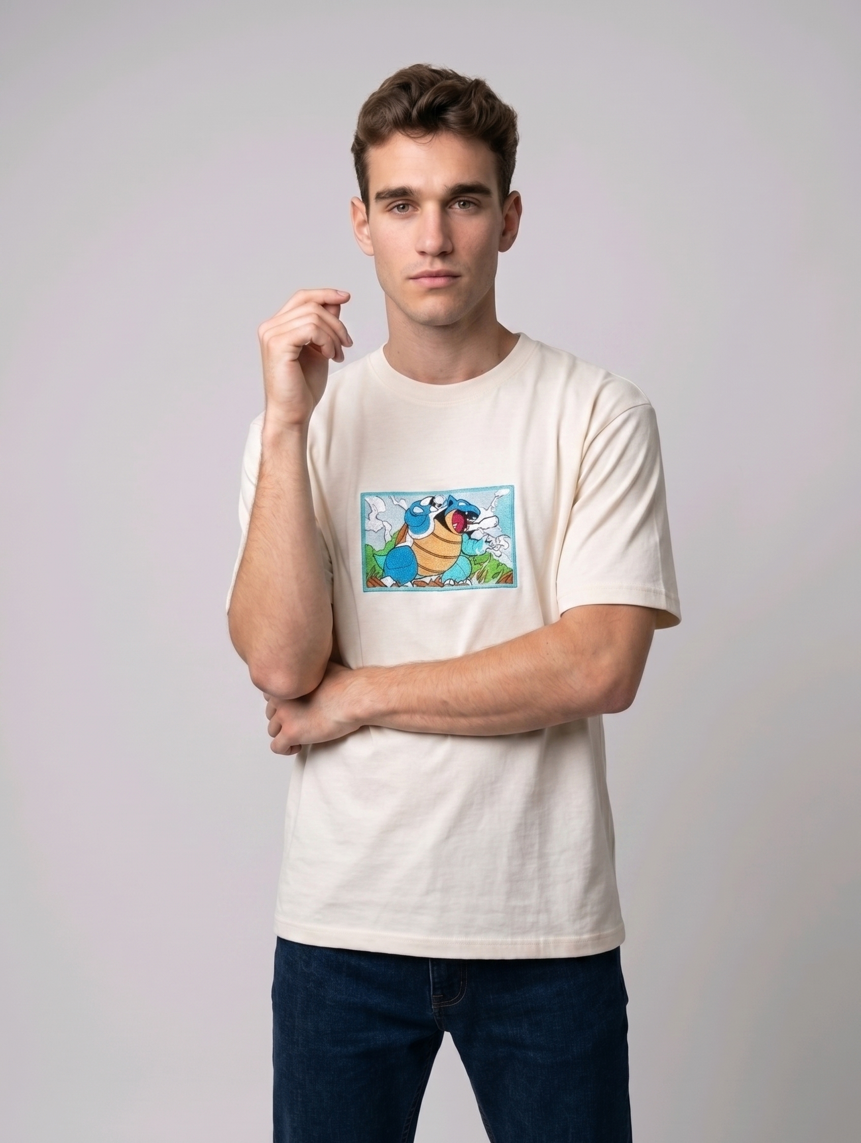 Front view of a off white heavyweight T-shirt showcasing a high-quality embroidered scene of the Pokémon Blastoise.