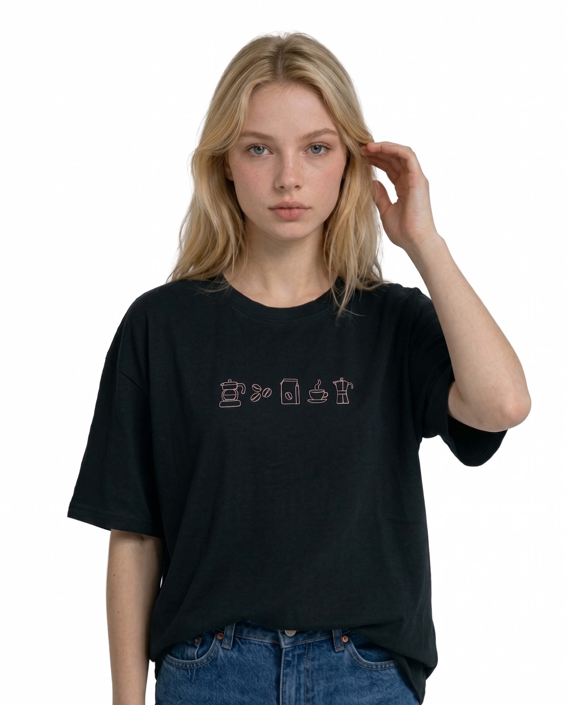 Wearing a cream-colored, crew-neck t-shirt. The center of the chest features a minimalist black line-art embroidery depicting a classic cafe storefront.
