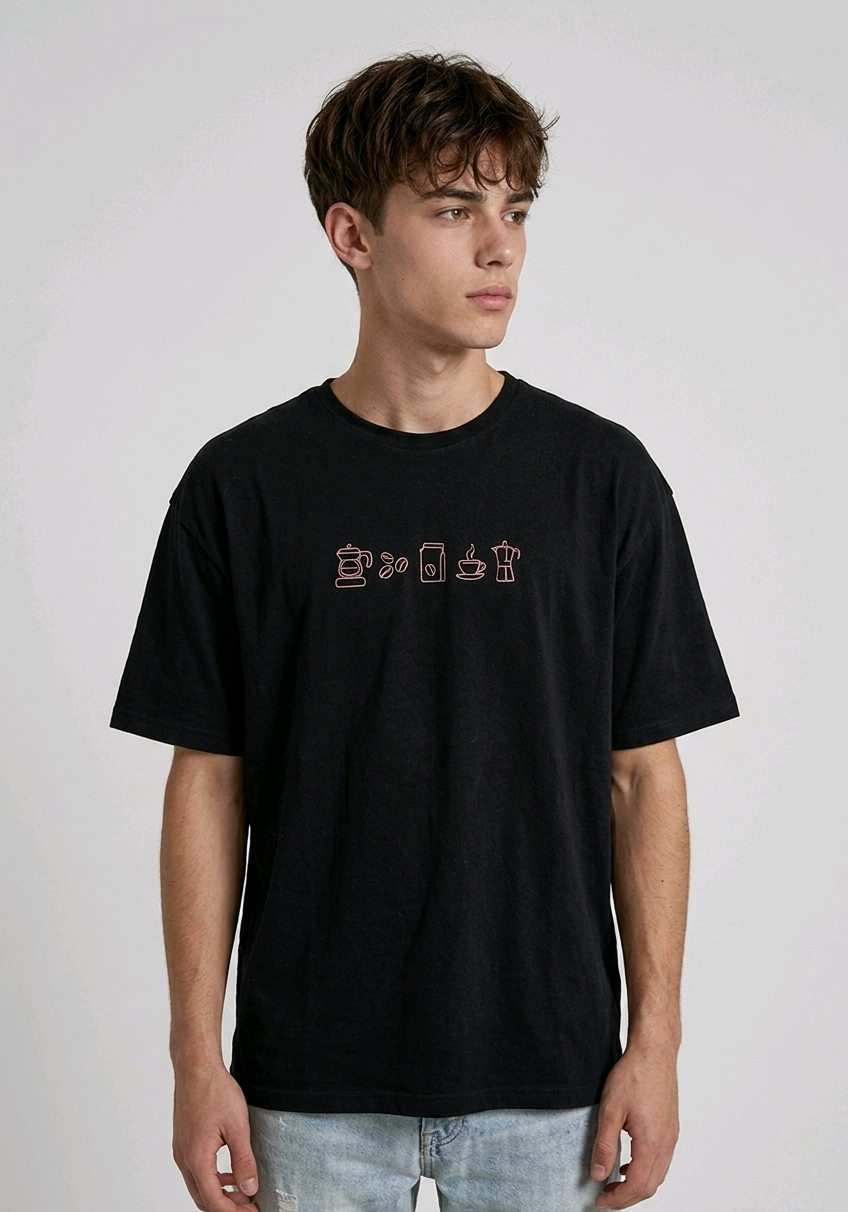 wearing an oversized, half-sleeved heavyweight cotton t-shirt. The chest features high-density direct embroidery of five minimalist coffee-themed icons in a horizontal row, including a French press, coffee beans, a coffee bag, a steaming cup, and a moka pot.
