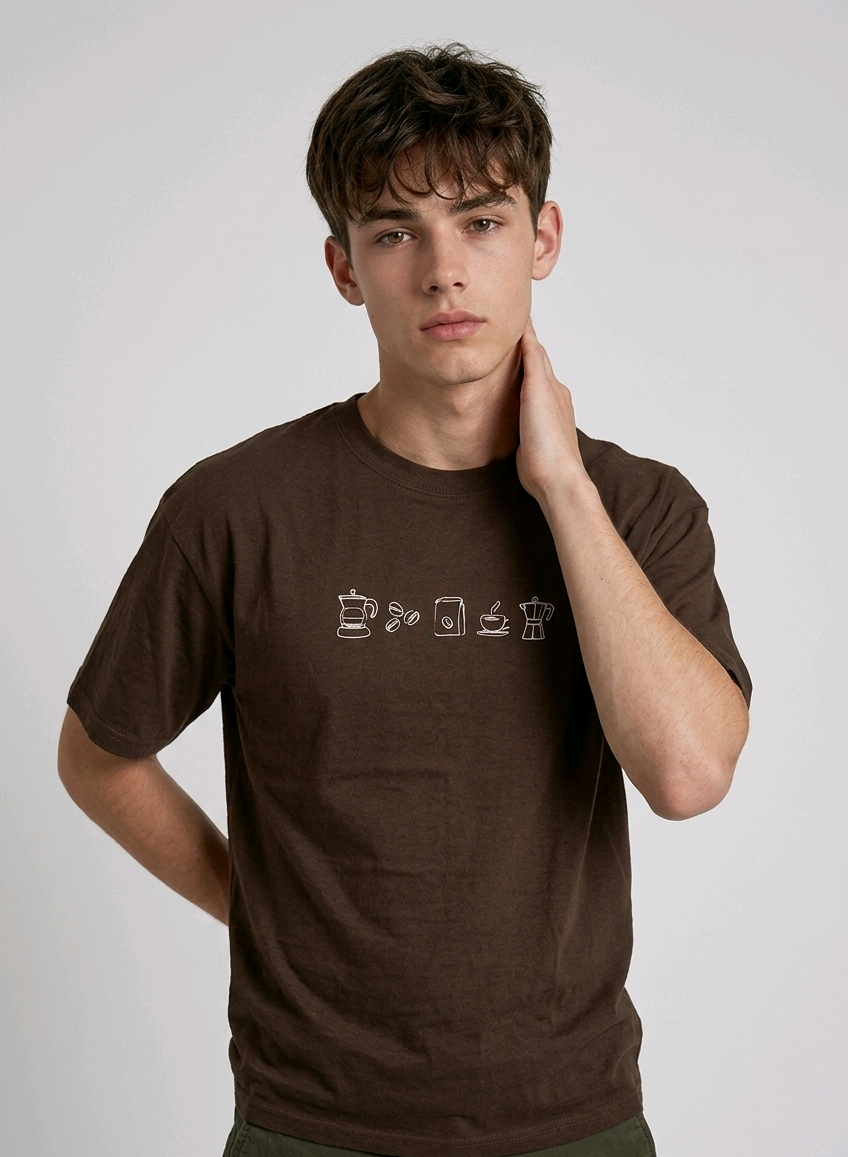 wearing an oversized, half-sleeved heavyweight cotton t-shirt. The chest features high-density direct embroidery of five minimalist coffee-themed icons in a horizontal row, including a French press, coffee beans, a coffee bag, a steaming cup, and a moka pot.
