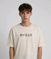 wearing an oversized, half-sleeved heavyweight cotton t-shirt. The chest features high-density direct embroidery of five minimalist coffee-themed icons in a horizontal row, including a French press, coffee beans, a coffee bag, a steaming cup, and a moka pot.
