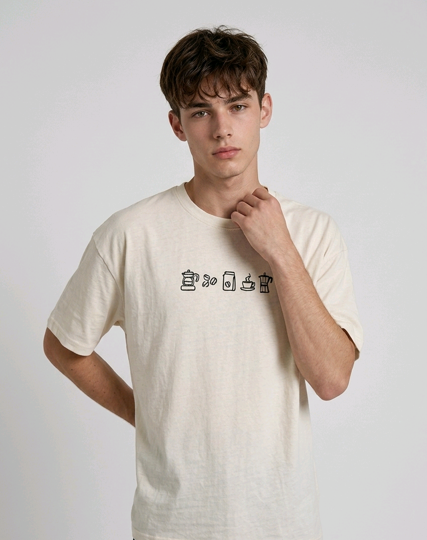 wearing an oversized, half-sleeved heavyweight cotton t-shirt. The chest features high-density direct embroidery of five minimalist coffee-themed icons in a horizontal row, including a French press, coffee beans, a coffee bag, a steaming cup, and a moka pot.
