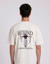 A male model from the back, wearing a black oversized t-shirt with a large, detailed embroidery design.
