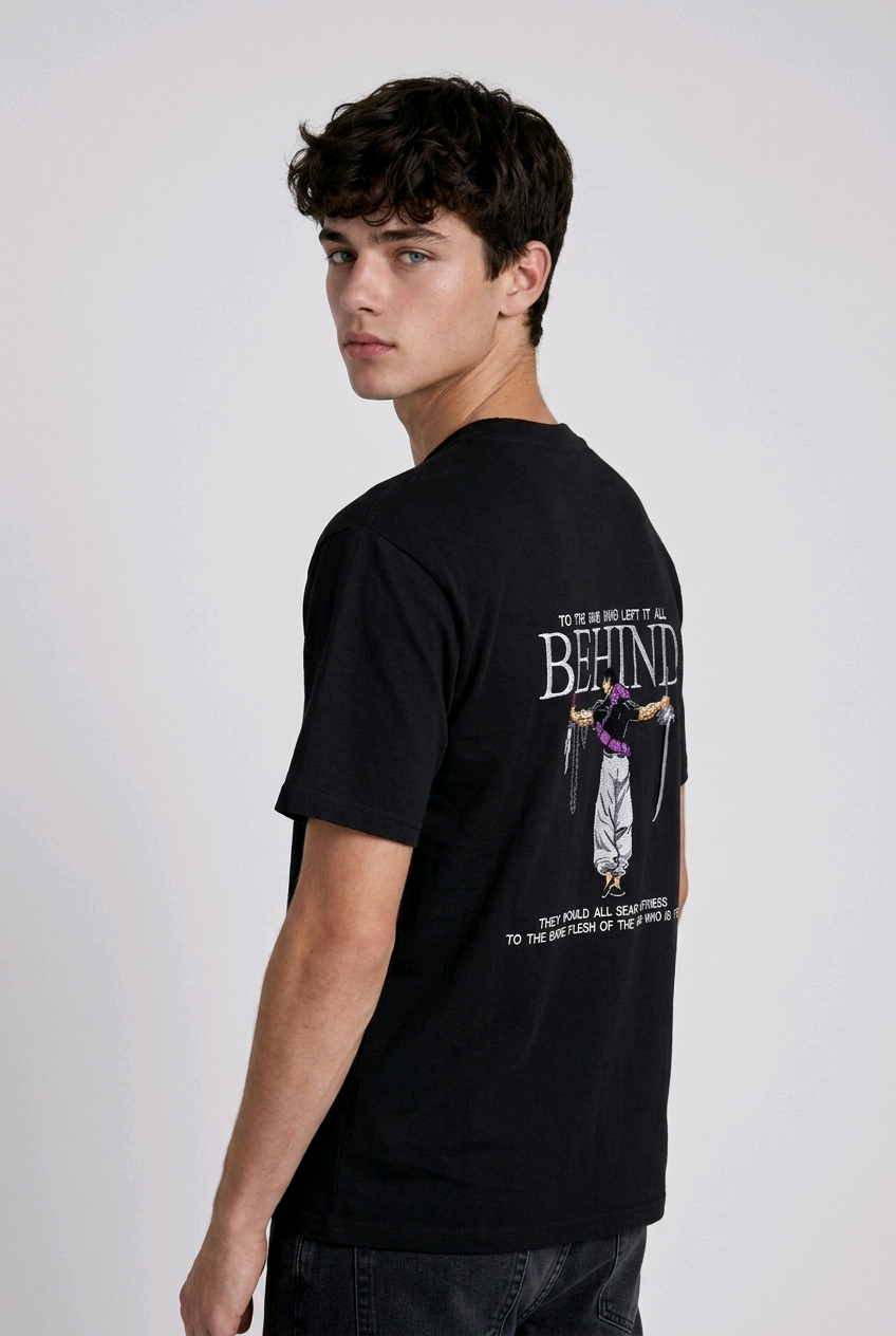 A male model from the back, wearing a black oversized t-shirt with a large, detailed embroidery design.
