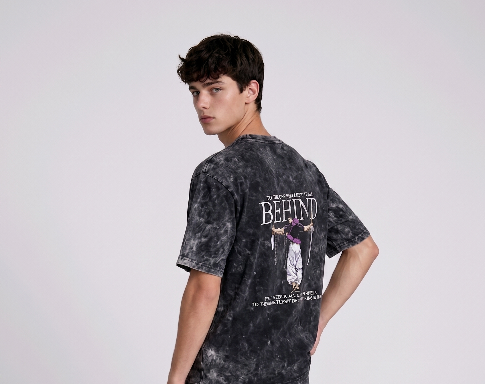 A male model from the back, wearing a Acid wash oversized t-shirt with a large, detailed embroidery design.
