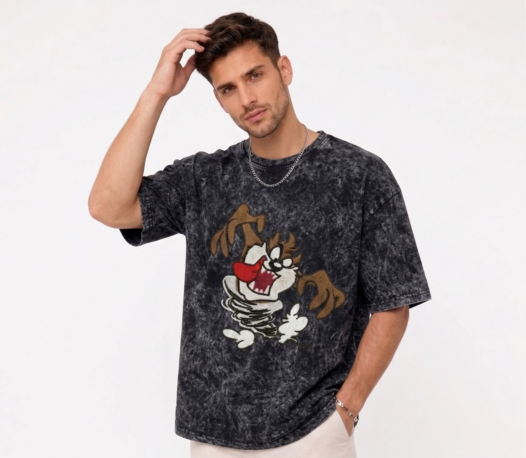 E-commerce product photo of a premium acid-wash streetwear t-shirt with custom character embroidery and a relaxed, oversized fit.