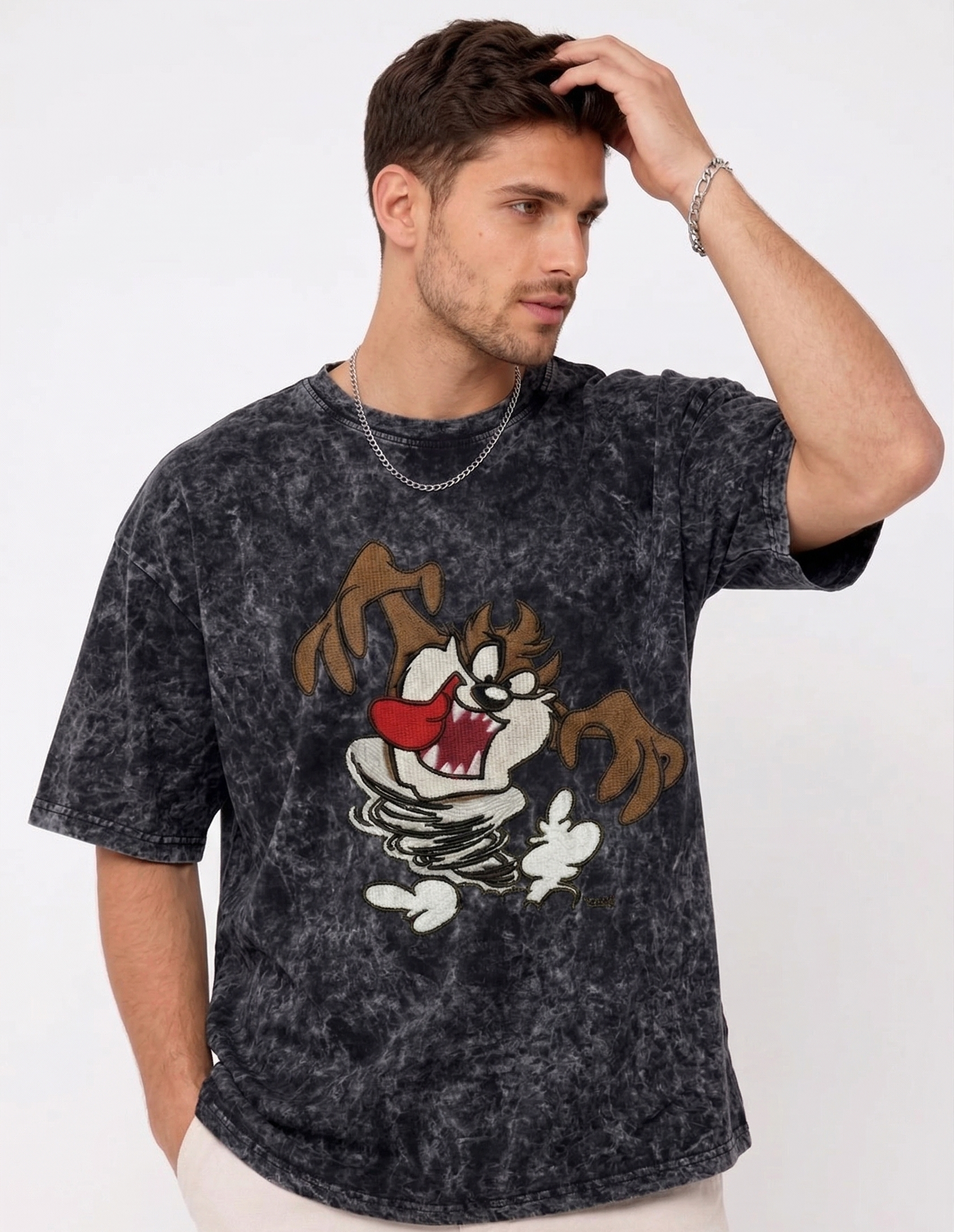 E-commerce product photo of a premium acid-wash streetwear t-shirt with custom character embroidery and a relaxed, oversized fit.