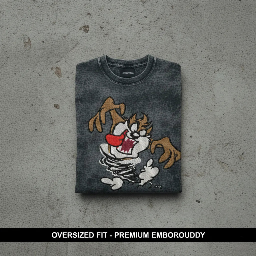 E-commerce product photo of a premium acid-wash streetwear t-shirt with custom character embroidery and a relaxed, oversized fit.