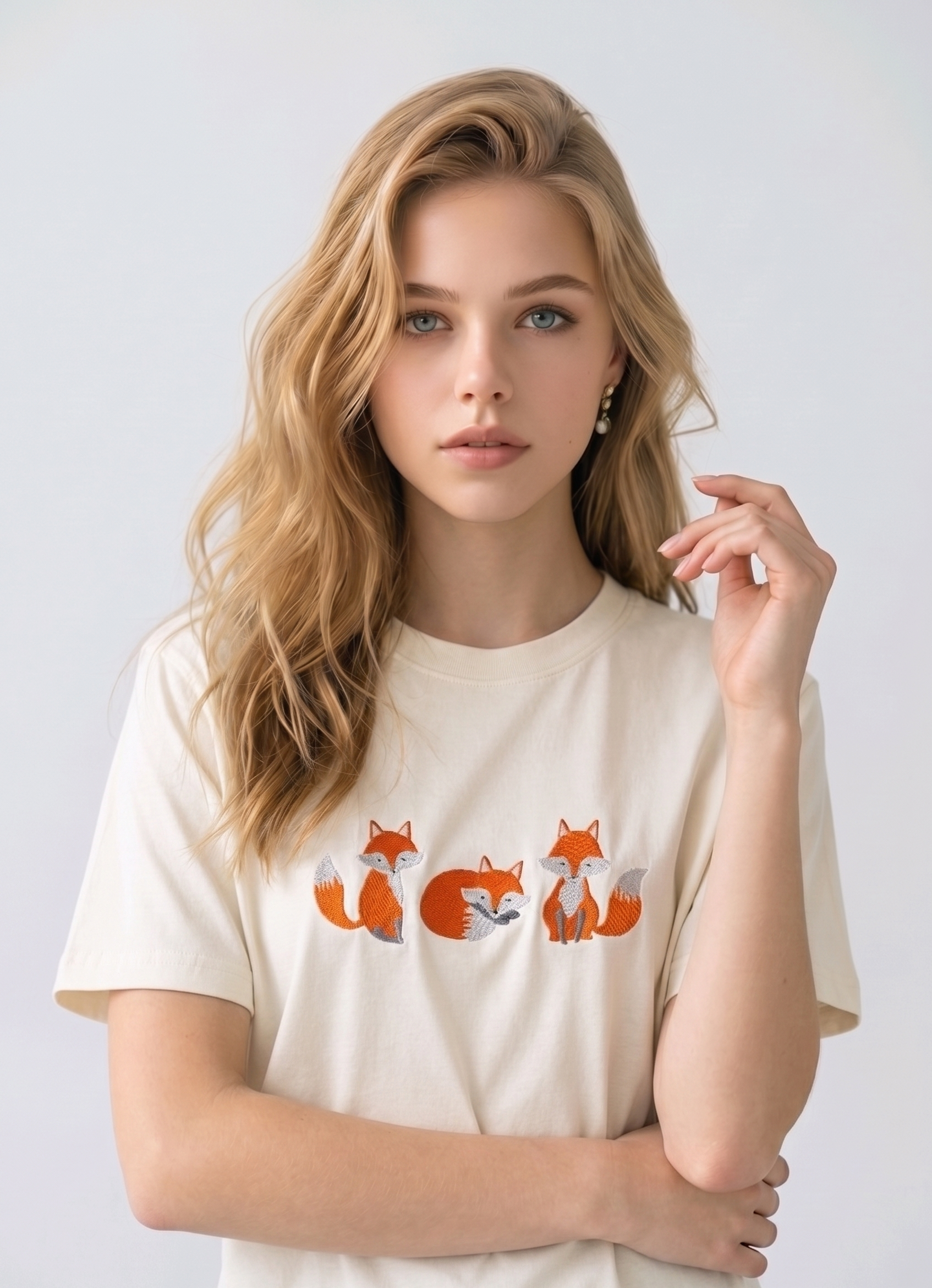 E-commerce model shot of a premium off white streetwear t-shirt with detailed animal embroidery and a relaxed fit.