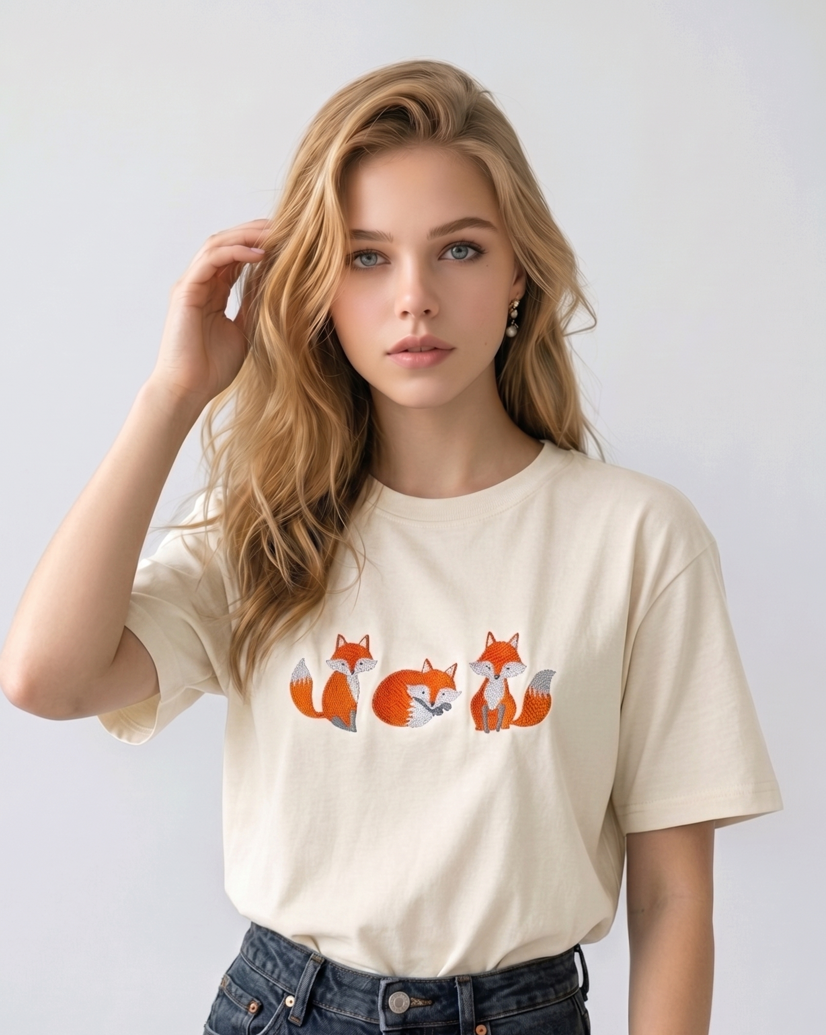 E-commerce model shot of a premium off white streetwear t-shirt with detailed animal embroidery and a relaxed fit.