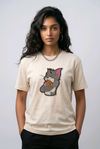 Woman wearing a beige t-shirt with a vintage Tom and Jerry cartoon patch.

