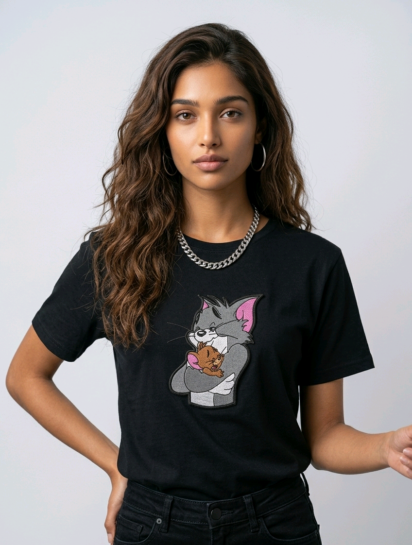 E-commerce product shot of a black streetwear t-shirt with custom character embroidery and a silver chain necklace accessory.