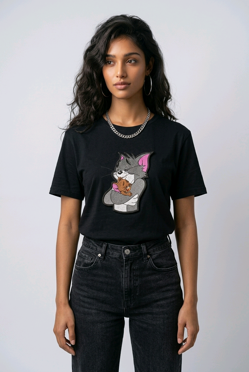 E-commerce product shot of a black streetwear t-shirt with custom character embroidery and a silver chain necklace accessory.